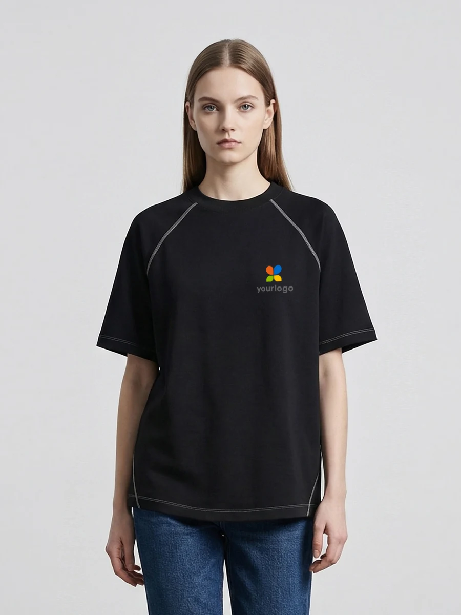Woman wears a black raglan short-sleeve tech wear top made of cloud-soft Modal, featuring a minimalist rainbow logo on the chest. The purist design embodies minimal street style, ideal for daily commute. Black colorway enhances versatility and modern aesthetic, blending comfort and sleek urban fashion.